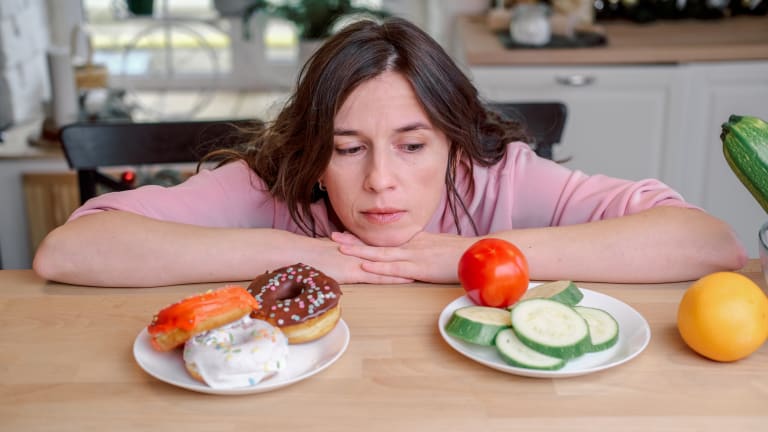 woman choosing between two meals