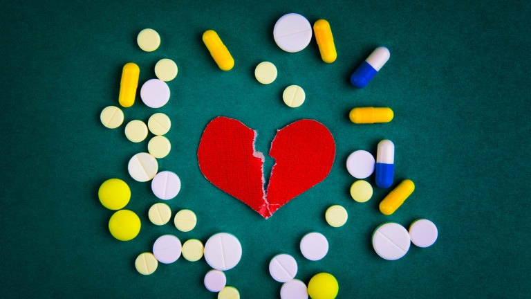 Medikamente und Symbol eines gebrochenen Herzens