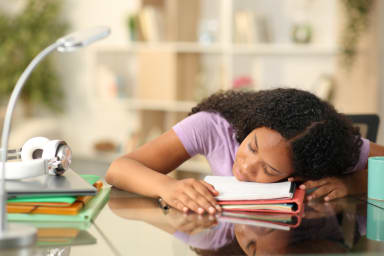 young woman tired sleeping on desk