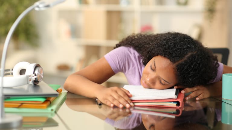 young woman tired sleeping on desk