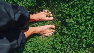 bare womans feet on lawn 