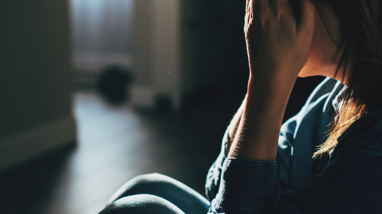 Sad woman sitting on the floor